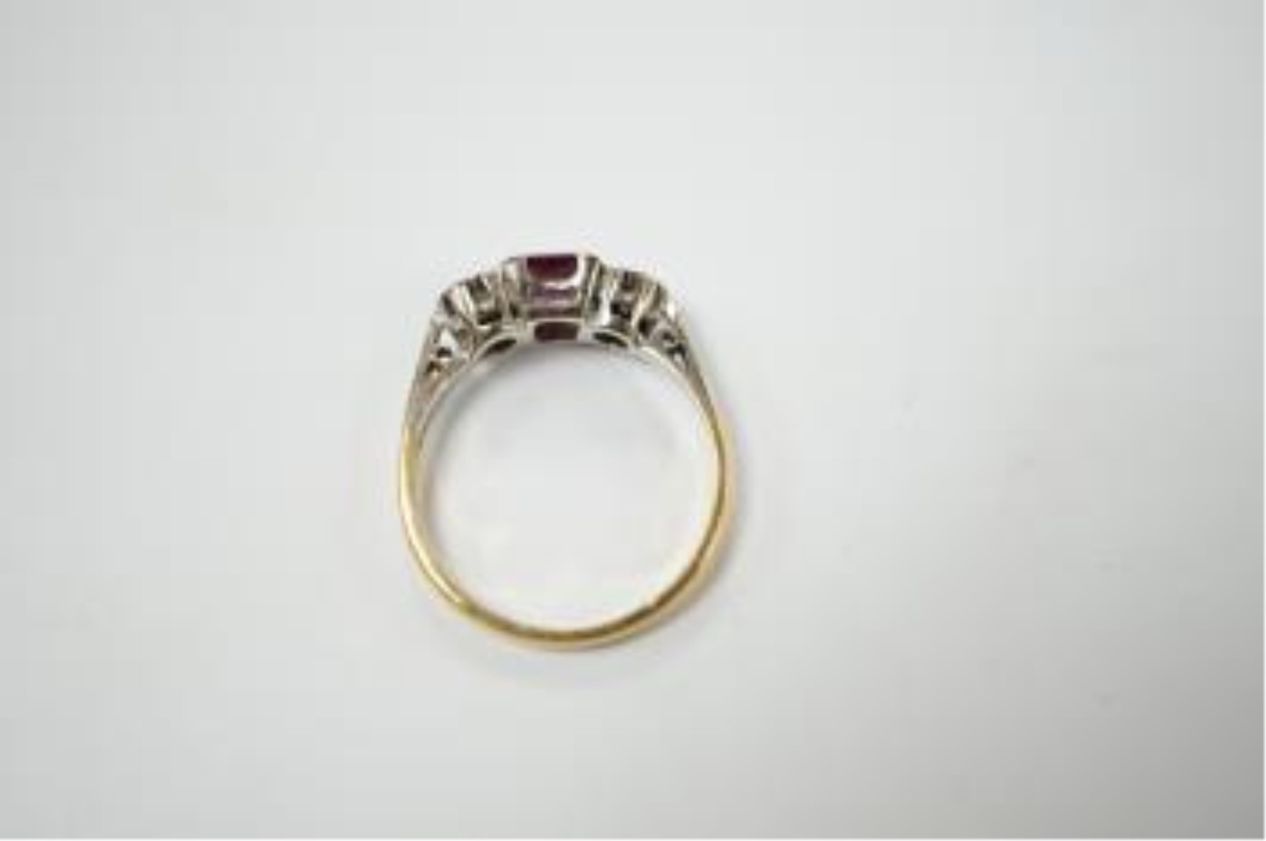 An 18ct & plat. ruby and diamond set three stone ring, size K, gross weight 2.3 grams. Condition - fair